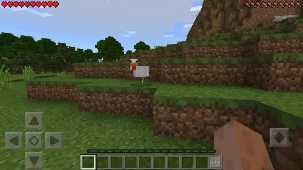 Minecraft APK gameplay showing a chicken in a grassy pixelated